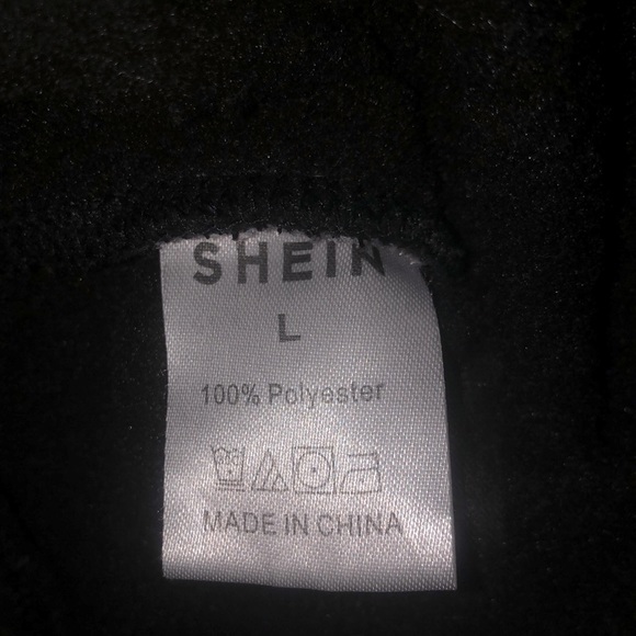 This is a Large womans sweatshirt from Shein. Black and white with blue pupils. - Picture 4 of 4